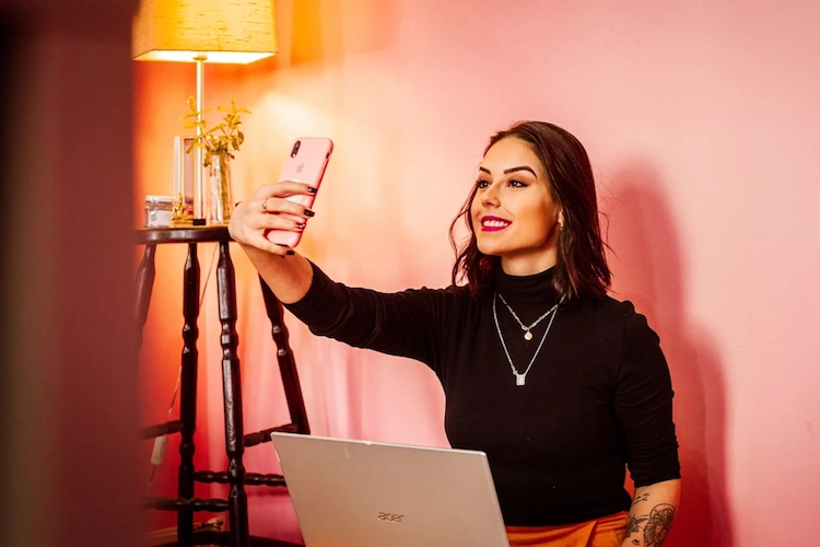 Female influencer taking a selfie in a studio